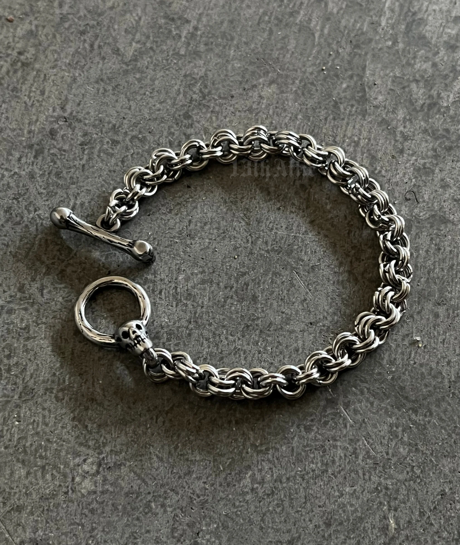 Handmade stainless steel chainmaille bracelet with a skull clasp, featuring an intricate weave and polished finish. A bold, edgy accessory perfect for gothic, biker, and alternative fashion.